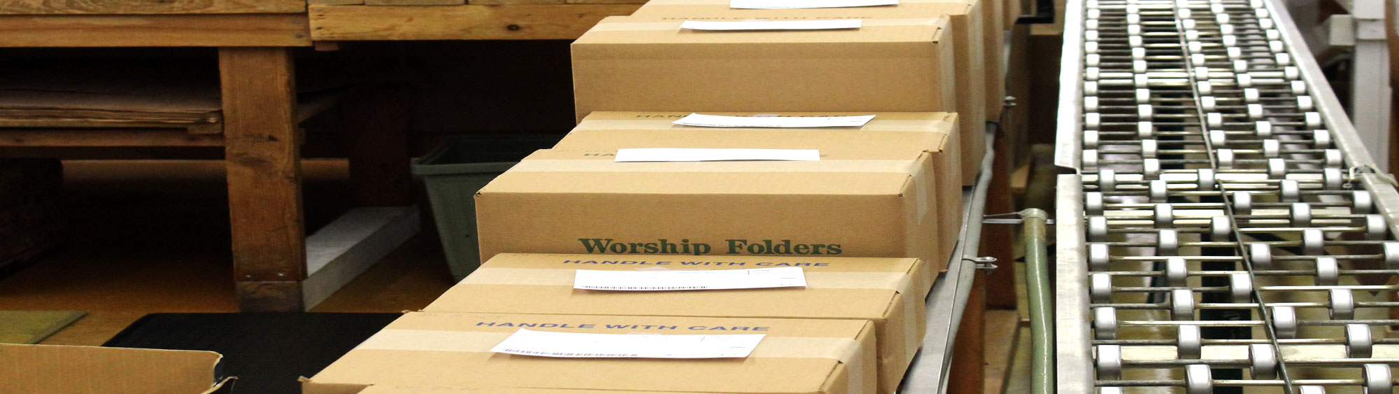 Shipping department with filled boxes and conveyor at Cathedral Press in Long Prairie, MN