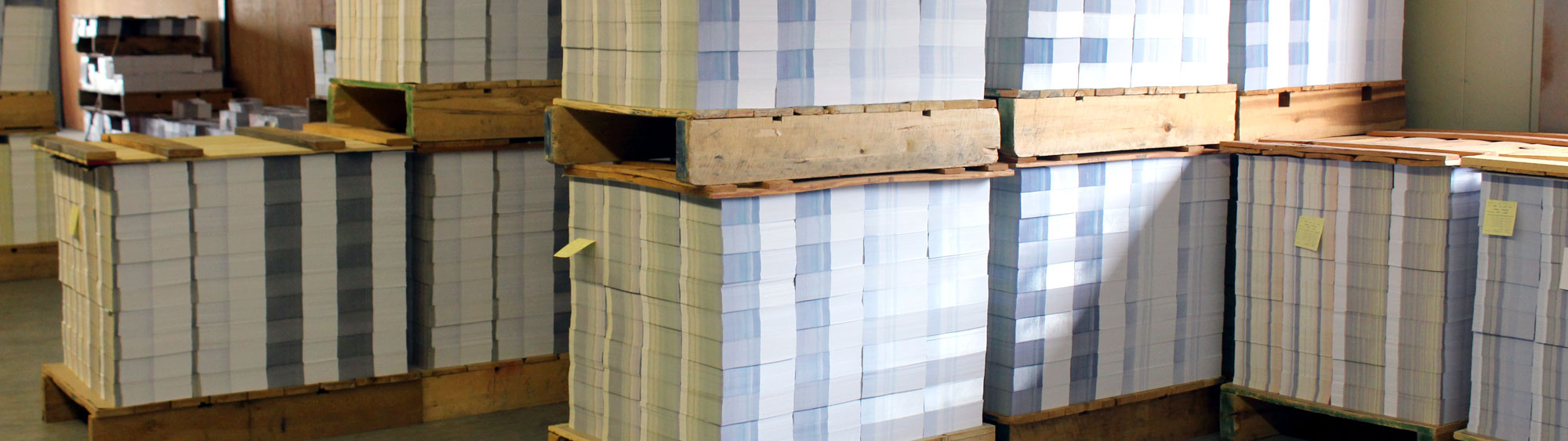 Palletized stacks of pre-printed weekly church bulletins awaiting shipment at Cathedral Press in Long Prairie, MN